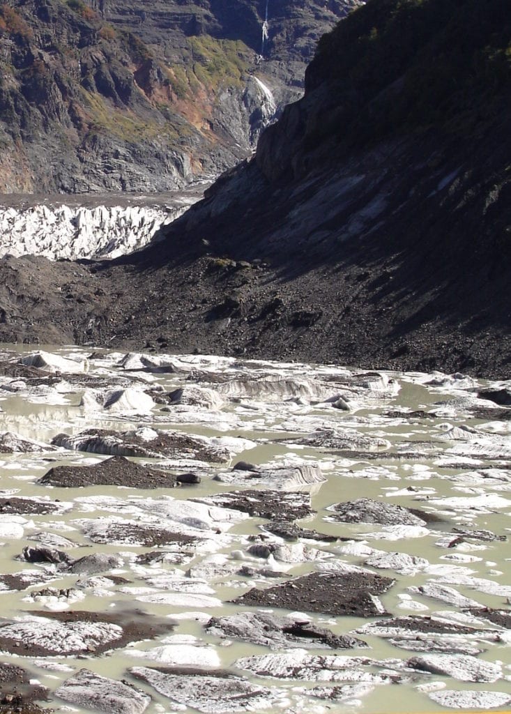 Mistura de gelo, cascalho e terra escura da montanha se misturam e formam uma lagoa de gelo, em Bariloche, Argentina